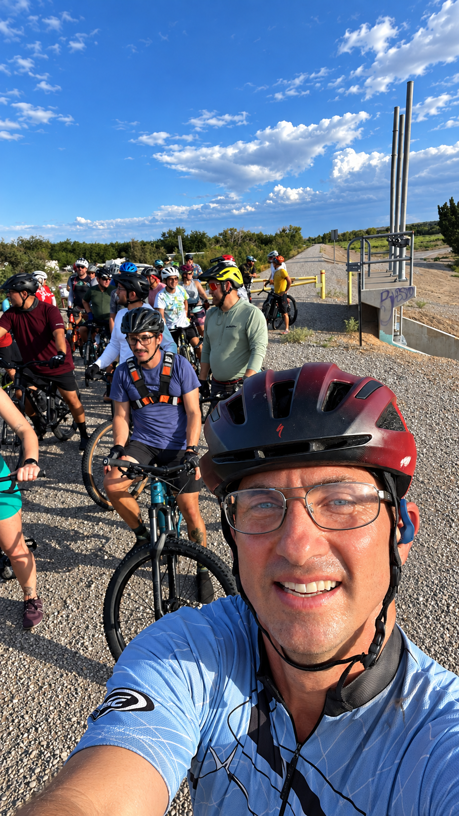Brett Stein taking a selfie with a large group of mountain bikers before a ride
